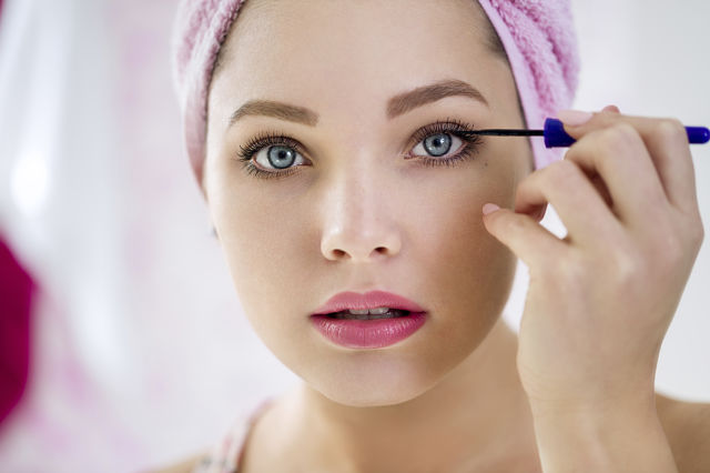 Close up of woman applying mascara