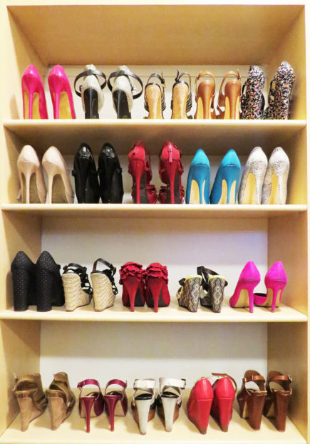 This composition shows a collection of woman's shoes in the closet.